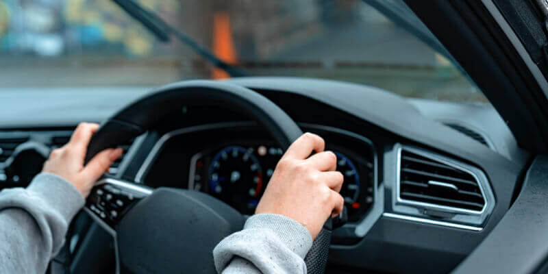 Hands gripping the steering wheel