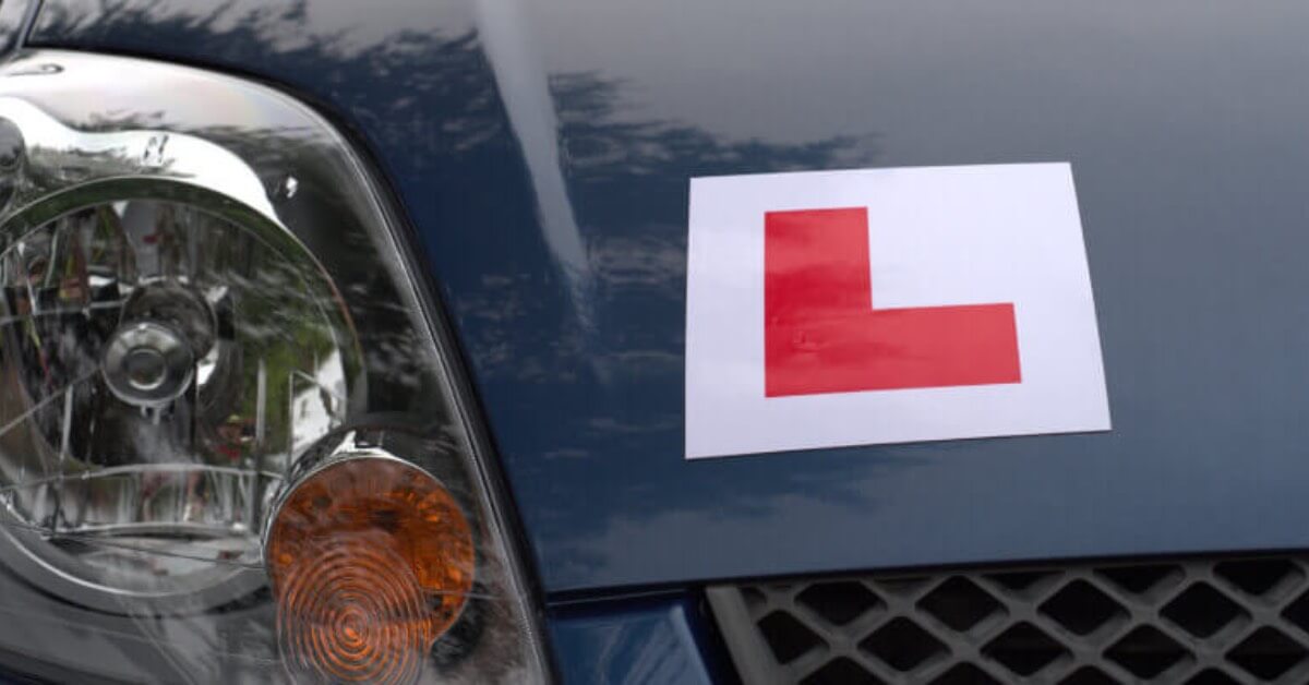 Bonnet of car with learner sign stuck on
